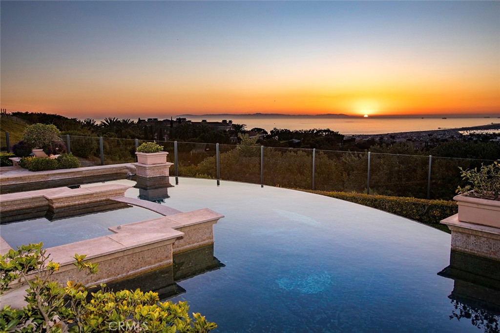 Situated on a front row unobstructed hilltop within Newport Coast’s coveted private custom community, Pelican Crest, this estate boasts coastal southern California grandeur throughout. Offering 9800 sqft of living space spanning across a 18,090 sqft lot the property showcases vistas of the white water coastline passed Newport Beach Harbor up to Palos Verdes with Catalina and year round sunsets resting in the backdrop. The calm tonal interior pallet evokes leisure and luxury reminiscent of the finest ocean resorts. With a focus on the extraordinary view all communal living spaces feature the textured endless horizon and accentuate the expansive feel of this home. Built across three levels, the main level hosts formal living/ dining, guest suite, wood clad office, kitchen open to informal living space, breakfast nook and covered loggias/ decks located throughout the perimeter. The subterranean level includes the 2390 sqft garage, secondary bedroom suite, laundry, gym, and entertainment room. The upper level contains the remaining secondary bedroom suites and the master retreat with ocean view decks spanning the entire rear of the estate. Outside, you will find beautiful hardscapes, lush landscapes, water / fire features, pool & spa, lounge spaces, expansive lawn, and BBQ station. This property and its picturesque setting represent coastal southern California living at its finest.