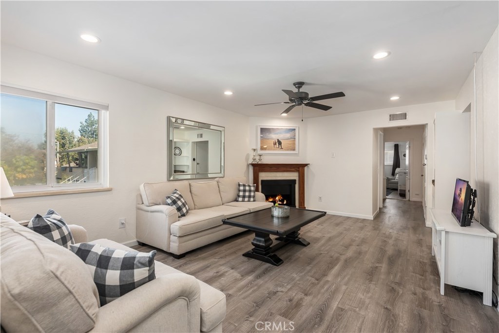 This beautiful, Move-In Ready Home is a Must-See. The light, bright and airy large 2 bedroom and 2 bath second story, end-unit condo has been recently updated in a fresh contemporary style. Updates include all newer bathroom fixtures, flooring, vanities with granite counters and main bath shower/tub combo; wood look flooring in living and bed rooms, newer light fixtures, fans and fresh paint throughout. In October 2018, a brand-new AC unit and all new duct work were installed too. The home has a large eat-in kitchen with granite counters, travertine backsplash and all newer appliances; nice- sized living room with fireplace and custom mantel. The home has ample storage with custom built-ins, office-nook in hall, master bedroom walk-in closet and storage cabinet in master bathroom too. The unit has a one-car garage and additional assigned parking space in complex. The well-maintained community features a pool, lush green belts, mature trees and professional landscaping throughout. The community is located in a desirable Orange neighborhood just minutes from Chapman University, Old Towne Orange, Angel Stadium, The Honda Center and Disneyland.
