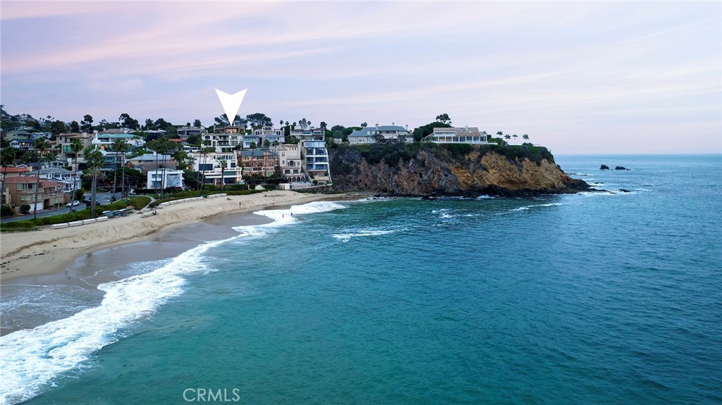 Luxury at this level is without compare. Experience timeless elegance, contemporary flair, and unyielding craftsmanship embellish in a stunning custom estate that is at one with 180-degree views of the Pacific Ocean, Catalina Island, and Emerald Bay. Embraced by the gated community’s iconic coastal pines, which date back decades to the early history of the virtually hidden bluff-top enclave, the spectacular residence reveals a commanding street presence that is impressive yet welcoming. Once inside, the home’s connection to the outdoors is evident on every level, with gracious patios and decks offering hidden gardens, sunny rooftop paradise, and sprawling main-level terrace accompanied by unobstructed ocean and bay views. Custom glass and wrought-iron entry doors set the scene, and interior spaces measuring approximately 7,119 SF provide an array of settings for grand-scale entertaining and easy, relaxed living. The open-concept main level showcases a grand foyer with a magnificent floating spiral staircase, great room that opens to the main terrace via glass sliding doors, and fully appointed kitchen with custom wood cabinetry, an island, separate breakfast room with private patio, walk-in pantry, and preferred appliances from Wolf, Fisher & Paykel, Sub-Zero, and Miele. Crowned by a towering cross-loin ceiling, the formal dining room opens to the outdoors via newer Fleetwood French doors. Four ensuite bedrooms and nine baths in a variety of configurations provide comfort for residents and guests, with the primary suite opening to a delightful meditation garden and offering two walk-in closets and a jetted tub. Custom mosaics, wood and stone-tile flooring, globally sourced handcrafted appointments, three fireplaces, newer separate generator, an elevator to all levels, and upgraded AV system are just some of the estate’s countless amenities. On the bedroom level, an inviting wood-paneled study displays a coffered ceiling, custom built-ins, one of the home's four wet bars, temperature-controlled wine cellar, and garden access. Catering to the automotive aficionado, an 11-car garage on the lower level presents boundless opportunities to create the ultimate show garage or entertainment venue. A versatile office is also featured on this level and includes a bath and kitchenette. Ascend to the rooftop deck by stairs or elevator and enjoy a fireplace, newer glass surrounds, newer above-ground spa, built-in BBQ, and dining area surrounded by breathtaking vistas.