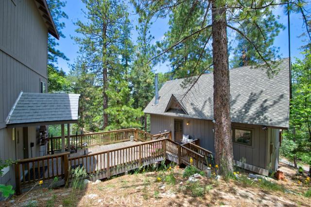 Lake Arrowhead Bavarian Charmer.Great setting surrounded by trees with a peek of the lake. 3 bd, 2 bath with detached oversized 2 car garage. Large space under garage that can be constructed into guest quarters, game room etc. Exposed beam ceilings throughout, wood burning fireplace and multiple decks great for entertaining. Lake rights. Well maintained and lovingly cared for awaiting its next owner.
