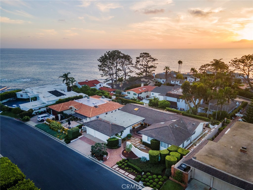 Imagine living in one of Southern California's most coveted gated communities, where luxury meets coastal charm. This single-level, ocean-view sanctuary in Monarch Bay sits on nearly a 1/4-acre lot, offering endless possibilities. Whether you're envisioning a personal touch on the existing home or dreaming of designing a custom masterpiece from scratch, this property is your canvas. With no interior steps, this home offers seamless living spaces where ocean views captivate from the main living area, dining room, and primary suite. High ceilings and abundant natural light enhance the spaciousness, creating an inviting atmosphere. The home boasts four bedrooms, 2.5 bathrooms, two living areas, a formal dining room, and a three-car garage, delivering both elegance and versatility. Picture yourself savoring breathtaking sunsets over the Pacific Ocean, with expansive west and south-facing views. Indulge in the resort-style amenities at the exclusive Monarch Bay Beach Club, where full-service beach setups, fine dining, a lively bar, cozy fire pits, and entertainment await you. This prime location embodies the essence of Orange County living, surrounded by world-class resorts like the Ritz Carlton, Waldorf-Astoria, and Montage Laguna Beach. You're steps away from stunning beaches, the vibrant Lantern District's luxury dining and shopping, and premier golf courses. A $500+ million renovation at Dana Point Harbor is underway, further elevating the area's allure. Nestled in a guard-gated community with no HOA fees and newly completed amenities including a sports court, pickleball, and upgraded entrances, this property is not just a home—it's a lifestyle. Your dream coastal retreat awaits.