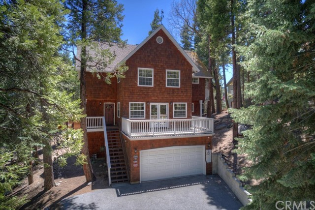 Located in the highly desired Summit area of Lake Arrowhead, you won't want to miss out on seeing this spacious home. Over 2100 square feet of living space and close to half an acre of land on a corner lot. This neighborhood has underground utilities making for more of a natural, peaceful surrounding. Lots of parking and a two car garage attached to the home. This home offers lots of natural lighting and plenty of deck space to enjoy and entertain. Main floor offers your living room with a river rock fireplace, a large kitchen with center island, and formal dining room with deck entrance. Head upstairs to your 3 bedrooms and additional family room. Master bedroom has its own deck as well as personal bathroom. Fantastic opportunity for full or part time living. Hot tub and furnishings included. Lake Rights too!