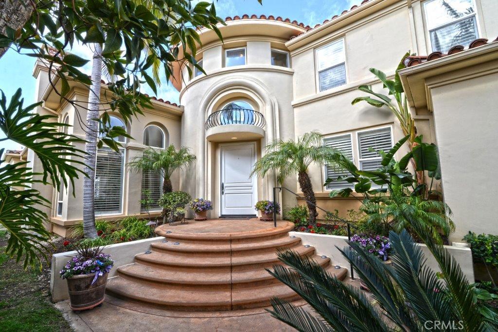 Enjoy ocean & canyon breeze from this modern living style residence in the gated community of Santa Lucia at Newport Coast. Highly sought after "Fari" floor plan. Dual master suites on 1st and 2nd floor. Gorgeous crema marfil stone flooring throughout. 1st floor extra large master suite comes with sitting area, fireplace, his/hers closets and Jacuzzi tub. Additional upstairs master suite can be converted to add another bedroom/suite. Main floor 2nd bedroom with full bath, ideal for guest/maid quarter. High vaulted ceilings with open layout. Recessed lights, premium sound system and security system. Custom high-end built-in bookcase and shelves, plantation shutters, kitchen granite counters. 3-car garage with new epoxy floor and built-in storage cabinets. 24 hours guard gated community, minutes from Pelican Hill Golf Course, beaches and Fashion Island. Convenient access to 73 Freeway.