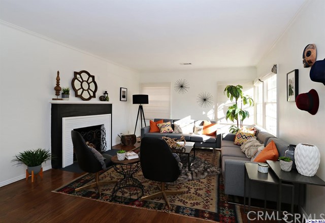 Picture perfect Silver Lake! This absolutely charming 3bed/2bath 2 blocks to sunset junction welcomes you home! A red-brick walkway pulls you past the grassy front lawn and into a welcoming and spacious living area w/hardwood floors and original fireplace. Around the corner, a traditional dining room w/ vintage chandelier waits to be filled with the voices of visiting friends and family while the adjacent chef's kitchen w/ granite countertops, stainless steel appliances, and chic tile backsplashes gives you all the tools you need to fix a meal they will never forget. When the summer sun calls you outside, escape to the private back patio where you can relax under the hardwood trellis or host a bustling evening get together w/friends and neighbors. The large two car garage provides alley access as well as a direct path to kitschy Silver Lake shops and dining and the infinitely stylish options further down on Sunset Blvd. You will never have to choose between a day at Griffith Park and a night at the ballpark again - it's all just a stone's throw away from your front door!
