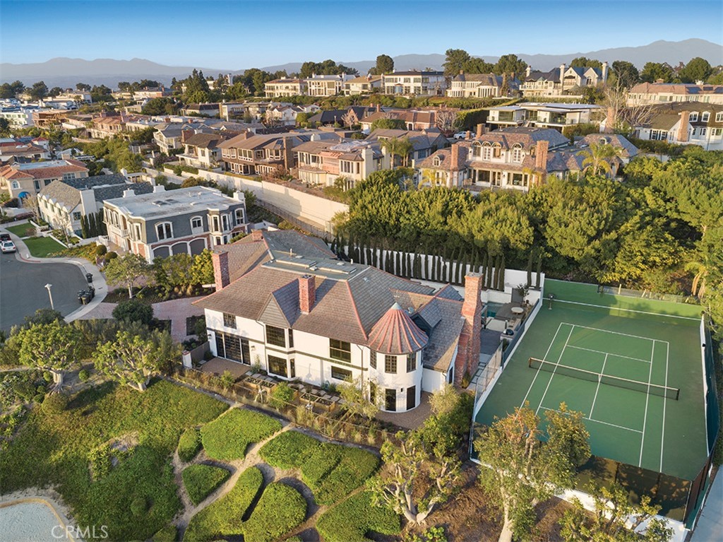 Ideally located behind the gates of ultra-exclusive Harbor Ridge, 2 Narbonne offers a once-in-a-lifetime opportunity to experience true Southern California luxury. The totally redone, approximately 7,550 square foot home showcases breathtaking ocean views on a roughly half-acre lot—a near-impossible combination to find in coastal Orange County. The estate’s contemporary aesthetic is bolstered by an open floor plan that invites everyday living and entertaining in six bedrooms and eight-and-one-half baths. The outdoor areas provide plenty of room to relax, featuring a professional size tennis court, pool, jacuzzi, large wood deck, and loggia encompassing a fireplace and outdoor kitchen with barbeque and pizza oven. Smart technology, including a Savant audiovisual system, Sonos audio system, Nest thermostat, and security cameras, makes life easy. On the main level, the newly renovated kitchen features a five-burner range, Lacanche oven, double dishwashers, white oak cabinetry, patinaed mixed metal fixtures, and slate floors. The dining room offers formal table seating with an adjoining sitting area for pre- and post-dinner cocktails and conversation. Enjoy an incredible master suite, complete with ocean views and dual dressing rooms, bathrooms, and walk-in closets. The estate also boasts a library and upstairs multipurpose lounge. Discover what it feels like to come home to 2 Narbonne today.