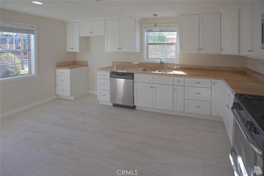 STANDARD SALE. Elegantly revived 2/2 in the quaint city of San Fernando. This beautiful home features a large living room, separate dining room with built-in corner cabinets, and a modernized kitchen with stainless appliances. From the moment you step in the home you can't help but appreciate the functionality of the floor plan. Enjoy wood flooring and fresh paint. There is a large front yard and the private backyard is perfect for entertaining with a built in wood-burning BBQ setup. Versatile and large space off garage could be used as a rec room, home office, man cave, or just extra storage. Assessor shows home as a 2/1 however it has a 3rd room that could be used as a bedroom and it also has a second restroom.