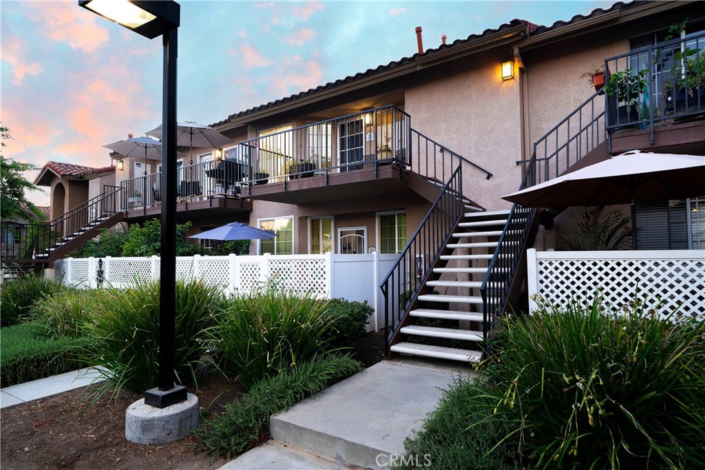 Discover the charm of this lovely 1-bedroom + loft residence with 1-car garage plus 2 parking spaces, offering peek-a-boo mountain views from the patio. Nestled within the beautifully maintained Mission Courts II community, and located just a minute’s stroll from the pool, spa, community BBQ area, and children’s playground. A short five-minute walk leads you to the serene Rancho Santa Margarita Lake, Beach Club with its swim lagoon, volleyball courts and nearby lakeside dining, Starbucks, and local grocery options. Step inside to an open, sunlit living space accentuated by soaring 2-story ceilings and expansive windows that fill the home with natural light. The versatile loft, complete with a walk-in closet, offers endless possibilities for a home office or guest space. The spacious downstairs bedroom features dual closets, and lit ceiling fan. Adjacent, the full bath offers added storage and a shower/tub combo. For your convenience, this home comes with a washer, dryer, and refrigerator, ensuring a seamless move-in experience. Ideally located just blocks from the highly rated Trabuco Mesa Elementary School and Monte Vista Park’s sports courts, soccer fields, tennis courts, and multiple playgrounds. Ranked the safest city in California in 2024, Rancho Santa Margarita offers an unmatched lifestyle. Residents enjoy access to the Beach Club, a splash pad, four Olympic-sized pools, fishing, 13 parks, picnic areas, and a vast urban trail system. The community hosts various events throughout the year, including the spectacular 4th of July fireworks. With the 241 tollway just minutes away, you'll enjoy quick access to Irvine and surrounding areas.