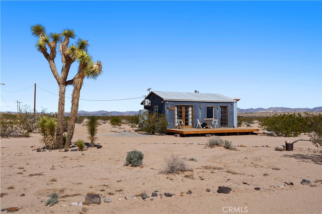 Escape to the serenity of the Mojave Desert with this authentic homestead cabin nestled on 5 acres of pristine land in North Joshua Tree. Surrounded by breathtaking desert vistas and iconic Joshua trees, this property offers the perfect blend of seclusion and inspiration for artists, adventurers, and nature lovers alike. Property has been upgraded with a fully-modern bathroom and ductless air conditioning and heating. Unparalleled Views—360-degree panoramas of the mountains, sunsets, and starlit skies. Minutes from Joshua Tree National Park, Pioneertown, and local amenities. Ideal for a weekend retreat, or creative getaway. Recreational cabins cannot be used as short-term rentals, buyer in investigate all uses and permitting. Furniture and Starlink equipment also available for negotiation.