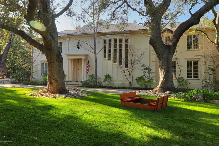 This timeless Georgian estate built in 1985 is a seamless blend of classic design and modern amenities. From the tree-studded lot to the exquisite chef's kitchen, this home is an entertainer's dream. Located on one of the most desirable streets in the city of La Canada Flintridge, the sweeping frontage, gorgeous wrought iron fencing, wide circular driveway, mature landscaping with extensive lighting are instantly inviting. Enter through the stately front door into a grand formal entry that leads to the formal living room, dining room and balcony, beautifully appointed with hardwood floors and detailed moldings. The chef's kitchen has custom millwork cabinets, top of the line appliances, marble countertops, oversized island, cooking fireplace, and is open to the stately but cozy family room. In the mahogany detailed family room with Juliet balcony, enjoy the built-in bar with ice maker, wine refrigerator and cabinets with brass detailing and dark marble countertop. Other amenities include maid's quarters, billiards room with bath and wine closet, gentleman's library with cherry wood ceiling, shelves and cabinets, pool/spa, 3-car garage, 2 laundry rooms, 4 fireplaces, 4 bedrooms suites, security system, leach line septic system and so much more.