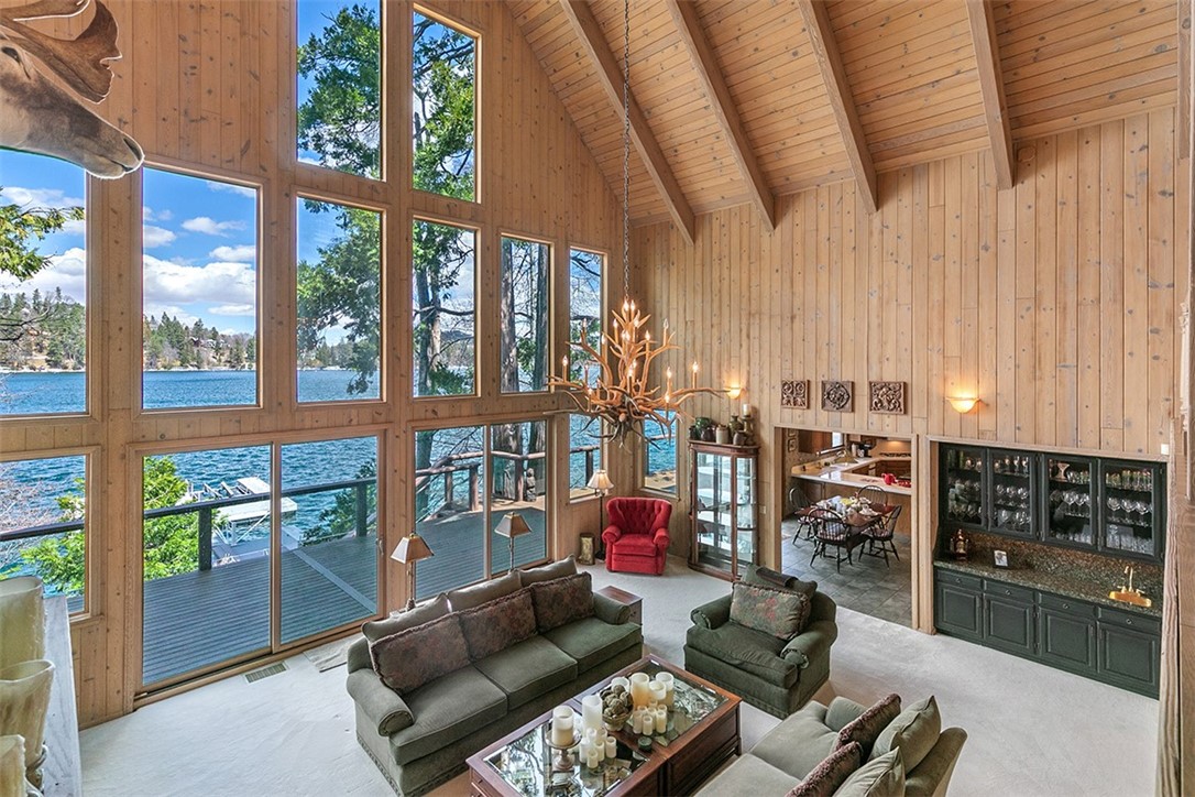 Situated on the Highly Acclaimed Gold Coast of Exclusive Point Hamiltair Gated Estates, this magnificent Lakefront Lodge is One of a Kind and the Lakefront positioning is Glorious, with unobstructed wide-open Lake Views and quiet Shoreline. While the Lodge is grand in scale there is a sense of warmth and comfort. The Lake Views throughout are Spectacular. The Primary Bedroom Suite is on 2 Levels with a Circular Lake View Sitting Room, 2 Fireplaces and Glamorous Bath! The Upper Level affords additional privacy and is separate from the sleeping quarters. Approximately 6,527 sq. ft. 4 additional Bedroom Suites. The Family Room is on the Main Level and there is a Rich, Warm Private Office. The fully equipped Kitchen has breakfast area and opens to a magnificent Formal Dining Room with Dazzling Lake Views! A lower level is the focal point for family entertainment, where there is a Pool Table, Spa Room, Bath and Sauna. The location is perfect with quick access to the Double Dock located directly in front of the Residence. The Main Living Room has a Magnificent Deck for large gatherings which overlooks the sparkling blue Lake. The grounds are Lush with Tall Trees! Circular Drive! 3 Car Level Garage. Premiere Positioning on gorgeous Lake Arrowhead Lake, California.