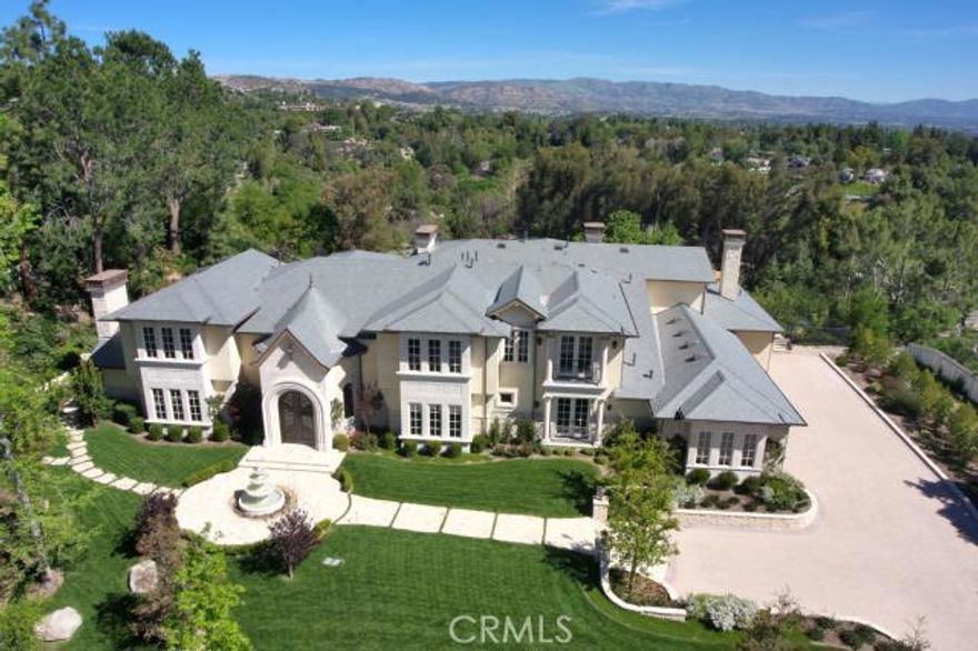 Absolutely gorgeous Country French Estate with panoramic views. Spectacular two-story entry opens an elegant dual staircase and sliding walls of glass. Superbly finished with excellent quality and craftsmanship throughout. Features include a chef's gourmet kitchen with huge center island, custom home theater with 125&#8221; widescreen and 7.2 surround sound, beautifully finished custom library, game room with wet bar and outside waterfall, large formal dining room with open beam ceiling and adjacent wine cellar, spacious family room with large custom fireplace, large luxurious master suite with volume ceiling, all stone bath, steam shower, spa, tub, large dual custom closets, 2 fireplaces, walk-out balcony and forever views. Amenities include a slate roof, stone & plank hardwood floors, &#8220;invisible&#8221; speaker system, granite & marble counters, all stainless steel appliances, Espresso center, mirrored elevator, multiple security cameras, barbecue & entertaining center, sparkling pool & spa with water feature, stone patios, mature oak and pine trees, fountains, lush landscape, privacy, and a wonderful private ambiance.