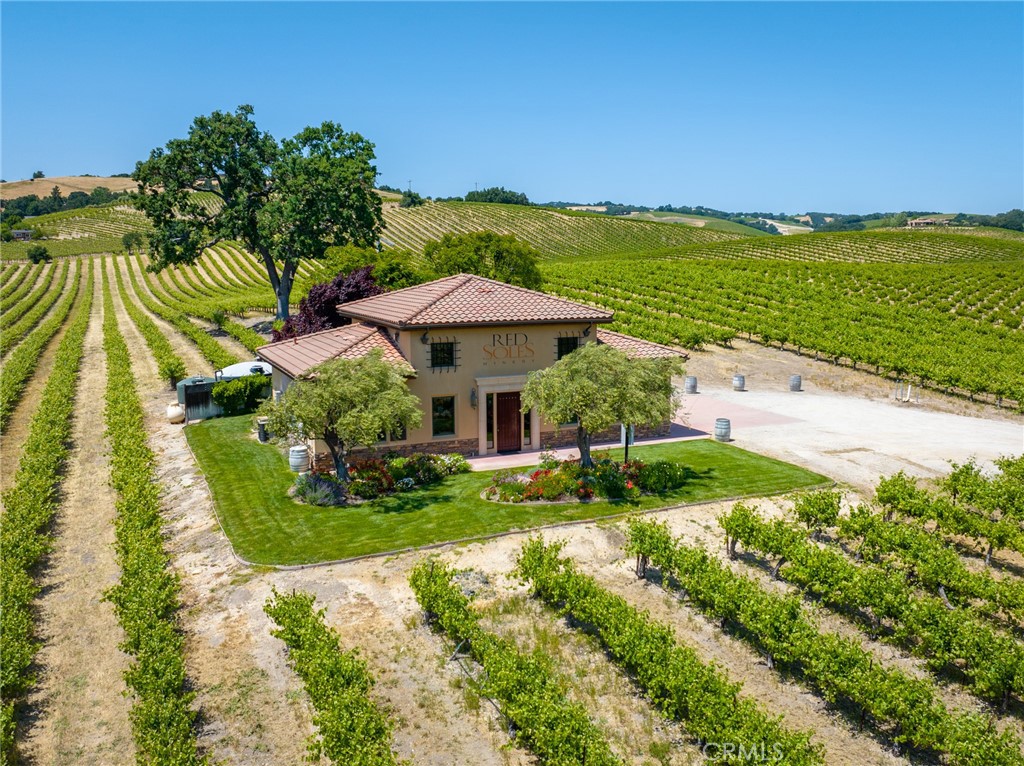 This 47-acre vineyard property, featuring 44 meticulously maintained planted acres, offers a rare opportunity in Paso Robles’ prestigious westside, within the coveted Willow Creek District sub-AVA. Known for limestone-rich soils, ideal elevation, and cooling coastal influences, this region is celebrated for producing complex, high-scoring wines. The vineyard includes 26 acres of Cabernet Sauvignon, 11 acres of Syrah, 5 acres of Viognier, 1 acre of Petite Sirah, and 1 acre of Chardonnay, offering a sought-after varietal mix. The vineyard is currently under contract for the next two years and is in the process of being Sustainability In Practice "SIP" certified. Neighboring acclaimed wineries like Booker Wines, this high-traffic location is perfectly positioned to establish or elevate a premium wine brand.
The property features a 1,500 sq. ft. winery and tasting room, complete with an inviting crush pad and patio designed to enhance the tasting experience. Breathtaking views of rolling vineyards and ancient oaks capture the timeless beauty of Paso Robles wine country. This is a rare chance to own a prestigious slice of one of California’s finest wine regions, where premium wines are crafted, and lasting legacies are built.