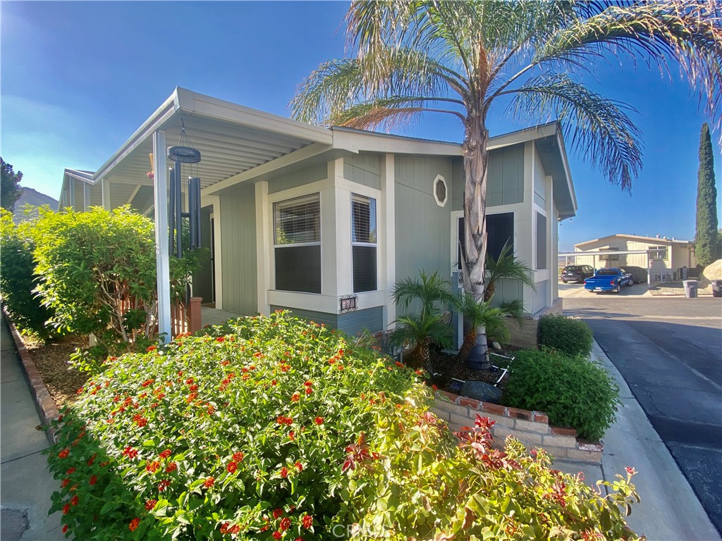 Pride of ownership at its highest level !!!!....Beautiful doublewide mobile home in a prime location corner lot at Saddleback. This is an ALL AGE, gated and family friendly mobile home park. This mobile home features three bedrooms and two baths. As you enter into this property a spacious family room with lots of natural light, beautiful built in cabinets and high ceilings will welcome you. To the right, a very private dinning room is located leading you to its gorgeous kitchen. Its kitchen displays, granite counter tops, a kitchen island with cook top, stainless steel appliances, large cabinetry and wood flooring. Master bedroom is very spacious, not to mention that double doors to master bathroom makes it look even bigger. Tile flooring, tile counter top, a separate walk in shower, a jetted tub, and dual sinks are some of the features in master bathroom. In the outside, a separate shed converted into a workstation perfect to work on big and small projects. Lots of bushes and tress including a mature orange tree. AC unit has being replaced within the last three years. Great mountains view right from your front and/or back door. This community is located within walking distance to schools, shopping centers, grocery stores, DMV, banks and for commuters quick access to Domenigoni Pkwy. Amenities offered include a recently renovated gated pool and spa, a recently added play ground, billiard room, basketball court, a library, RV and boat storage. There are too many good things about this property to cover them all...come on by, take a look and make it yours!!!