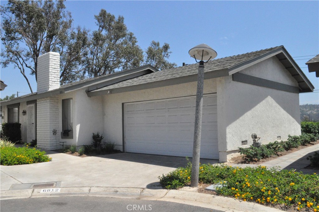 Stand alone condo with attached direct access 2-car garage, much like a single detached home, in widely popular Woodgate Community in Yorba Linda. Newly painted exterior, newly planted, stone-paved walkways and newly landscaped surroundings make this community a welcoming place to live in. Equally inviting is the high ceiling that greets you as you come in. Newly painted interior in neutral color so you can just move in and settle. Wood laminate floor throughout, newer kitchen cabinets and newer double-pane patio door. Paved backyard with city lights view of Anaheim Hills. Newly scraped ceiling and in orange peel finish. Community amenities include club house, swimming pool, tennis, basketball and handball courts. Very close to shopping, restaurants, movie theaters, regional park. Easily accessible to the 91, 55 and 57 freeways and Imperial Highway.