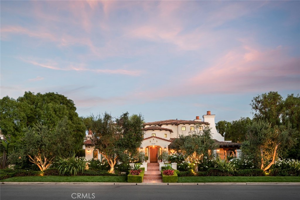 A landmark in Newport Heights, on an exceptionally rare double lot, this gorgeous Spanish Colonial home is sure to please even the most discerning buyers. The rare combination of prime location, architectural integrity, authentic details, and the best modern amenities, make this one of the most distinctive properties in Newport Beach. Upon entering, you are greeted by dramatic 20’ wood beamed ceilings complimented by custom wrought iron details, plaster curved walls, and elegantly arched windows and doors providing light and access to the numerous surrounding courtyards, lawns, and gardens. Superbly scaled public rooms and gourmet kitchen with stainless steel appliances allow ease for large entertaining or intimate gatherings. The generous primary suite is complete with dual bathrooms and dual walk-in closets, cozy fireplace and private veranda. 3 additional bedrooms with ensuite bathrooms and walk-in closets complete the home. Numerous pepper, olive, palm, and citrus trees highlight the several meticulously manicured outdoor spaces. 4 car garage, separate laundry room, office… the list of amenities goes on and on. Ideally located on a quiet street, a short bike ride to sunny California beaches, and just minutes from world class dining and shopping. Welcome to your own private oasis.