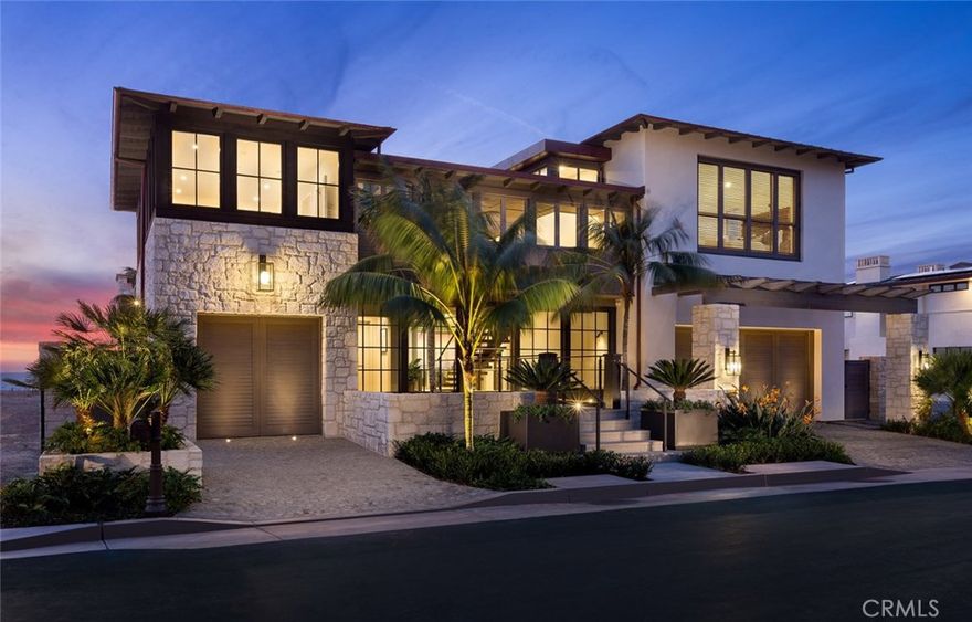 Twin Palms is a NEW beachfront estate tucked away in the exclusive gated coastal community of The Strand at Headlands. This elegant and livable showplace features 9,300 square feet of exquisitely appointed, contemporary, covered living space designed by renowned architect Bob White and built by Carl Akins. Inclusive to the home are six bedrooms with en suite baths, grand entertaining areas, and a private oceanfront swimming pool. Inside, contemporary touches have been artfully mixed with classic architecture creating a comfortable design that is perfectly suited to the oceanfront setting. The two story entry hall is framed in floor-to-ceiling bronze windows and lined with hand set limestone walls. Inside, a series of light and airy indoor spaces are virtually indistinguishable from inviting outdoor spaces that unfold as you approach the ocean. The beach level features more entertaining areas, while opening to covered terraces and the infinity pool set above the sand. The full-floor master suite is a spacious sea view retreat bathed in cool ocean breezes and warmed by the afternoon sun. Backed with a ten-year new home warranty, every detail in this custom residence was carefully designed and expertly crafted to a level simply without compare.