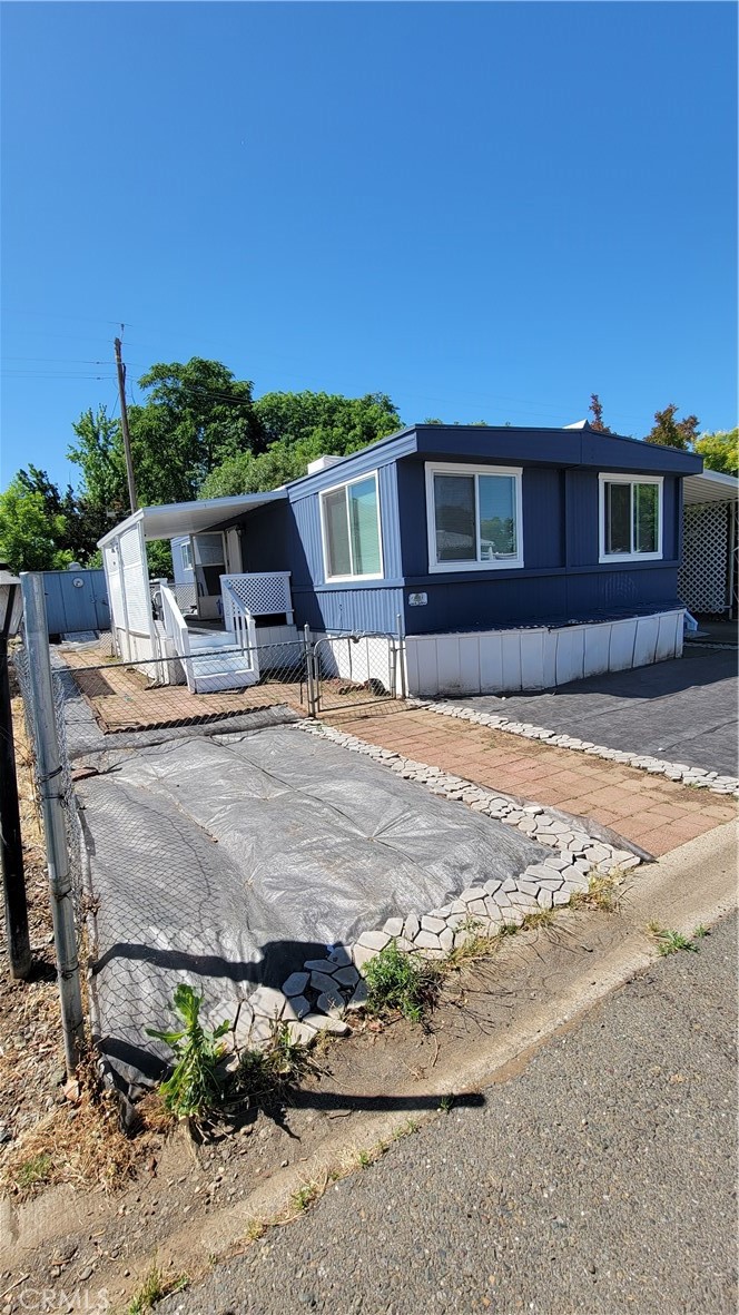 Cute place in a desirable 55 plus park has new paint new flooring, It has a new ac unit and the front deck has been replaced. The back yard has fruit trees and a shed. There is a nice carport and ramp. Landscape was started its ready for the new owners to make it your own look. The roof was recently coated. This park has a rec room and a swimming pool.