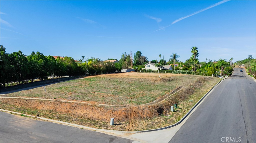 Discover the perfect opportunity to build your dream home on this expansive 41,382 sq. ft. corner lot, located in the highly desirable Woodcrest community of Riverside. Zoned A-1-1 (Light Agriculture, 1-acre minimum lot size), this versatile property allows for single-family residences, agriculture, and certain equestrian uses, making it ideal for those seeking space and flexibility. Surrounded by custom homes, this lot offers stunning views and a peaceful rural atmosphere while remaining close to city amenities. The spacious layout provides ample room for a custom estate, guest house, workshop, barn, or RV parking. Conveniently located near top-rated schools, shopping centers, dining, and major freeways, this property offers the perfect blend of privacy and accessibility. Whether you’re looking to build your forever home or invest in land in one of Riverside’s most sought-after neighborhoods, this is an incredible opportunity. Don’t miss your chance to own a prime piece of land and bring your vision to life!