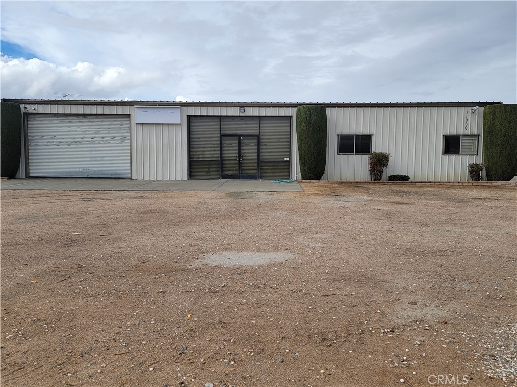 Rare opportunity to purchase a property in the I2 zone (heavy manufacturing) of Hesperia and the owner will also consider leasing. The warehouse is 3000 sq.ft with an office/retail space and an open warehouse area. An additional 1180 sq. ft. of secured storage with roll up doors, shelving, and lights allows the owner t to stock parts or use the space as an additional workspace. A chain link fence topped with barbed wire surrounds the entire 1.64 acres with a gate in the front and two side gates that lead into the lower yard. There's also a fenced area inside the yard for securing vehicles or machinery. The property has cameras and an alarm system. There's one 12x16 roll-up door and glass receiving doors on the side of the building.