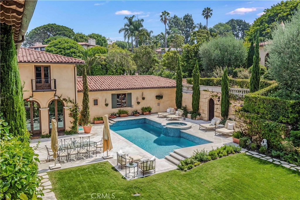 Situated on nearly an acre of lushly landscaped grounds, this custom-built estate awaits. Majestic, yet comfortable, this home has it all. An impressive entry immediately sets the tone with dual staircases. Multiple living spaces include a grand living room overlooking the amazing backyard, a handsome “man-cave” / library, a large formal dining room and a spectacular family room. The chef’s kitchen has a center island and adjacent breakfast room. There’s even an office or 6th bedroom off the kitchen. Upstairs, you’ll find 5 large bedroom suites, including the palatial master-suite, complete with his and her separate bathrooms, 2 walk-in closets, and a large sitting room. Outdoors, you’ll find numerous verandas and patios, a large grassy yard, as well as a sparkling pool and spa. Do you like wine? Enjoy a magnificent wine cellar with tasting room. Last, but certainly not least, guests will enjoy a private two-room Guest House, complete with fireplace. The gated driveway leads to the spacious 4 car garage. Air conditioning, high ceilings with crown molding, and expansive views of the ocean, coastline and city lights are just a few of the “extras”.