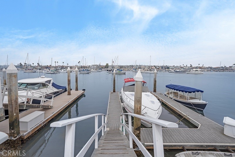 This traditional, Shingle-style, bayfront home is brimming with character and is poised on a prime corner lot in the W Bay neighborhood of the Balboa Peninsula. With spectacular views of the Newport Channel and nightlights of Fashion Island, and within an easy walk of the Peninsula’s famed white sandy beaches, all of the fun of Newport Beach is out your front door including swimming, sailing, surfing, paddleboarding, boogey boarding, Volleyball, electric boating to your favorite restaurant or bar, and strolling or bike riding on the “World Famous” boardwalk. The first level of the home features a Dutch door entry, hardwood floors, a brick fireplace, a family room with a fireplace, a full bath, laundry room, 3-car attached garage, and a luxurious Island kitchen with custom cabinets, granite countertops and GE Monogram stainless steel appliances. The upstairs of the home is highlighted by the waterfront master suite with panoramic views, vaulted ceilings, a fireplace, and a luxurious bath with marble countertops, Jacuzzi tub, and a separate shower. In addition, there is a private guest suite with a private bath, a hallway bathroom, bedroom, a built-in office, loft area and two-bedroom suites that share a Jack-n-Jill bath. The bayside patio has endless water vistas, grass, gardens, brick details, and leads to the private pier and boat slip that can accommodate a yacht to 54’ and a side tie. W Bay Avenue is anchored by the Newport Harbor Yacht Club to the east, and the American Legion to the west, and is an easy bike ride or walk to the Marina Park and all the nightlife and activities at the Newport Pier. This home can be purchased with most furnishings, making it an easy move-in opportunity.