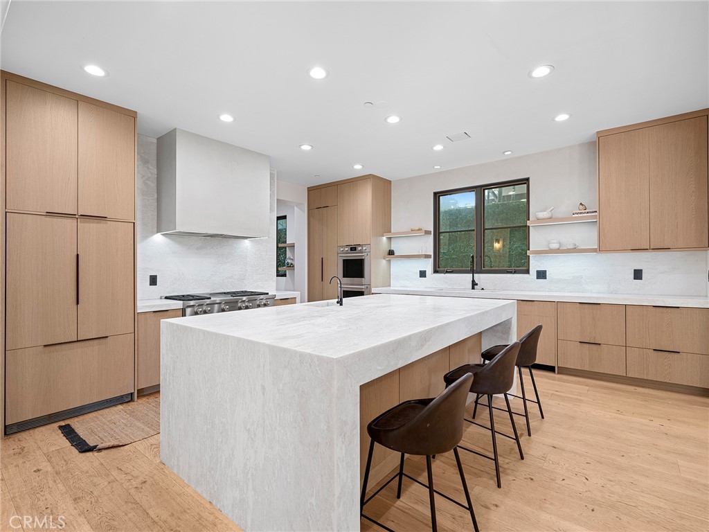 Encompassing over 6,100 square feet of living space, this meticulously updated 5 bedroom, 6 bathroom custom Newport Heights home showcases a wealth of recent enhancements. Stepping inside, the residence boasts all-new hardwood flooring throughout, complemented by urban-inspired tiles in key areas. Each of the interior bathrooms has been completely revamped with new tubs, toilets, tiles, RH fixtures, and Waterworks fixtures. The master bath is a luxurious retreat featuring Coocoon fixtures, a steam shower, and blackout glass, while the master closet has been elegantly redesigned. Lime wash paint lends a sophisticated touch to the master suite, enhancing its appeal. Not stopping there, the property includes a remodeled powder room and a fully renovated kitchen equipped with new appliances and marble countertops. The fireplace has been updated with full marble, and the laundry room now boasts new washer and dryers. Throughout the home, updated lighting fixtures, including chandeliers, add to the ambiance. Additional enhancements include new cabinets in the office and family room, creating ample storage space, as well as a new entertainment system with speakers installed outside. The bar and wet bar have also been tastefully remodeled, perfect for entertaining guests. Beyond its interior designed by Nesrine Interiors, this home offers an impressive array of features, including high ceilings, a dramatic foyer with a stunning curved staircase, and custom beamed ceilings in the family area. The entertainer’s backyard beckons with a built-in BBQ, lounge area with TV, and a recently added custom pool/spa. The expansive master suite features a private patio, wet bar, fireplace, and a generously sized California Closet-organized closet. Four additional bedrooms and a bonus room/loft round out the versatile floor plan, ideal for a game room or media area. With its proximity to world-class beaches, top-rated schools, and the vibrant 17th street amenities, this home epitomizes luxury coastal living at its finest.