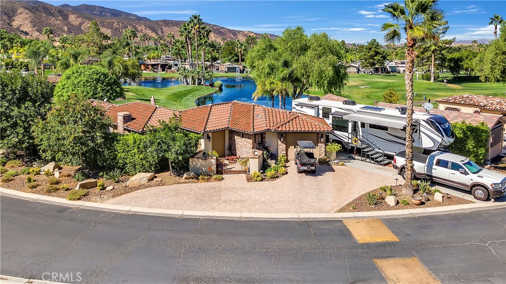 Welcome to Rancho California RV Resort. This spectacular lot is the largest in the Resort at 7405 square feet with an approximately 1,600 + square feet of Build-Out created for comfort, privacy and entertaining. Resort Living at its finest! The lot overlooks a soothing lake with fountains and the golf course. Expansive views of the 4th and 5th fairways and some entertaining golf-play. The large patio is an entertainer’s dream with built-in BBQ, breakfast bar, lounge areas, a gorgeous succulent garden and gate to the greenbelt with a short walk to the 4th tee. The exterior of the build-out features beautiful stonework and large areas with pavers for additional parking. The interior build-out offers a modern kitchen with top-of-the-line appliances, farm style hammered copper sink and granite counters. Also included is a service area for washer/dryer/storage. The spacious living room is perfect for cozy nights by the fireplace and the adjacent bar is perfect for entertaining. The formal dining room opens to the patio for warm summer nights or enclosed for warmth during the cooler evenings. Electric heating is included in all rooms. Wood beams and ceilings are distressed wood which creates a homey atmosphere. The resort includes 5 pools, multiple lakes, including the main “catch & release” lake, golf course, tennis courts, pickleball courts, horseshoe pits, bocce ball court, 4 laundry rooms, bathhouses, a restaurant, a very nicely stocked grocery store and church on Sunday. There are also 2 clubhouses and even a gym. Entry to the resort is controlled by an automated gate system with manned attendants 24/7. This lot is the diamond of the resort and will sell quickly. Fifth Wheel and Truck are not included but are available to be purchased separately. Please call for your private viewing.