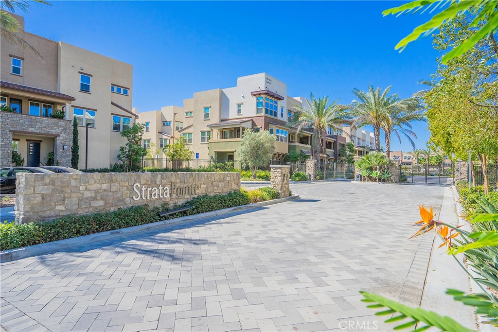 ABSOLUTELY SPECTACULAR BUILDER'S MODEL HOME in the highly desirable Gated Community of StrataPointe by TRIPointe Homes in 2018! Welcome to this beautiful 2 bedrooms/2.5 baths with 1,493 sq ft of living space with extensive designer upgrades. This home features hardwood, tile & carpet flooring, upgraded modern kitchen with quartz countertops, tile backsplash, matte thermofoil cabinetry & pendant lights, open rail stair system, recessed lighting throughout the house, solar electric system, epoxy garage floor, electric car charger, ceiling speakers, custom motorized blinds & plantation shutters, and smart home systems (home automation-ready, wifi thermostats, Ring doorbell, smart keyless entry door). Main floor features an open floor plan with kitchen, dining, and living room leading to a spacious private balcony for relaxation, and upgraded bathroom. Above the main floor, there is a large master bedroom with dual sink vanities, separate toilet room & walk in closet, 2nd bedroom with walk in closet & bathroom, and laundry room. Community amenities include a resort like pool/spa with showers/restrooms, outdoor fireplace, BBQ/picnic areas, cozy sitting areas with waterfall, and a children's playground. Convenient location near the 5/91 fwys, shopping centers, restaurants, entertainment, and the Buena Park Metrolink Station. Come see all that this beautiful home has to offer.