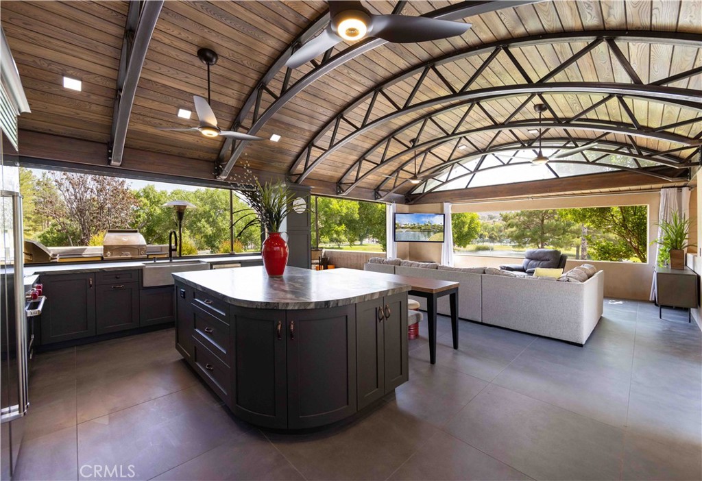 Experience RV living at its finest in this stylish casita lovingly called “The Garage”. This home boasts of architecture reminiscent of a 1950s service station. Walking through the entry door you’ll be wowed by the expansive arched, custom-made wooden ceiling. An abundance of natural light dance through the generous openings which have been fitted perfectly with remote controlled electric screens. You’ll experience a world of warmth and comfort as you step into an open concept living space which includes a gourmet kitchen, nicely appropriated dining space and a comfy gathering area perfect for creating lasting memories with friends and loved ones. To the right of the gathering area, you’ll find a hallway that includes beautiful, custom-made cabinetry where the front load washer and dryer are hidden. Stroll on past and you’ll find a private den which is perfect for your home office. Returning to the kitchen, the Wolf propane cooktop with electric oven is conveniently located near the Sub Zero 42” refrigerator. This gourmet kitchen also includes a commercial GE convection/microwave oven, custom-made cabinetry and leathered quartz countertops. No matter what you’re serving, clean-up is made easier with the oversized concrete apron sink and the mini-Bosch dishwasher. There is plenty of hot water to wash dishes and clothes thanks to the 220-volt recirculating water heater. Just off the kitchen and gathering areas is a private terrace where you can sit and savor your morning coffee as resort views unfold before your eyes. Three Sirius, square umbrellas tilt and rotate providing shade while enjoying the views. Cooking on the LYNX 36” rotisserie built in barbecue grill or in the LYNX 30” countertop pizza oven will make any cook look like a professional chef. Embrace the tranquility of this beautifully landscaped oasis with top-notch amenities just a stone’s throw away. This Class A Motorcoach only site could be your private retreat at Rancho California RV Resort. Call to discuss details for your private showing. Rancho California RV Resort provides amenities such as a 14 hole Executive PAR 3 Golf Course (no fees for owners), 5 Pools/Jacuzzis, Tennis courts, Pickleball courts, Dog park, Club house, hiking trails, Horseshoe lawn and onsite grocery market. The resort is guard gated with no age restrictions. Monthly HOA fee includes "unlimited" use of the golf course, amenities, trash pickup at lot, water/sewer and common area maintenance. *Financing is available*