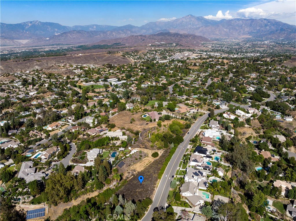 Gently sloping lot with sweeping panoramic views located in a wonderful neighborhood near the Country Club. Prime South Redlands location surrounded by multi-million dollar estates. Perfect lot for a split-level home - think Hollywood Hills architecture. Utilities are at the street. Close to schools, shopping, restaurants, downtown Redlands, ESRI, University of Redlands, Redlands Community Hospital, and Loma Linda University. The seller will offer a package deal if a buyer also makes an offer on 0 E Sunset Drive N, MLS: EV22212276