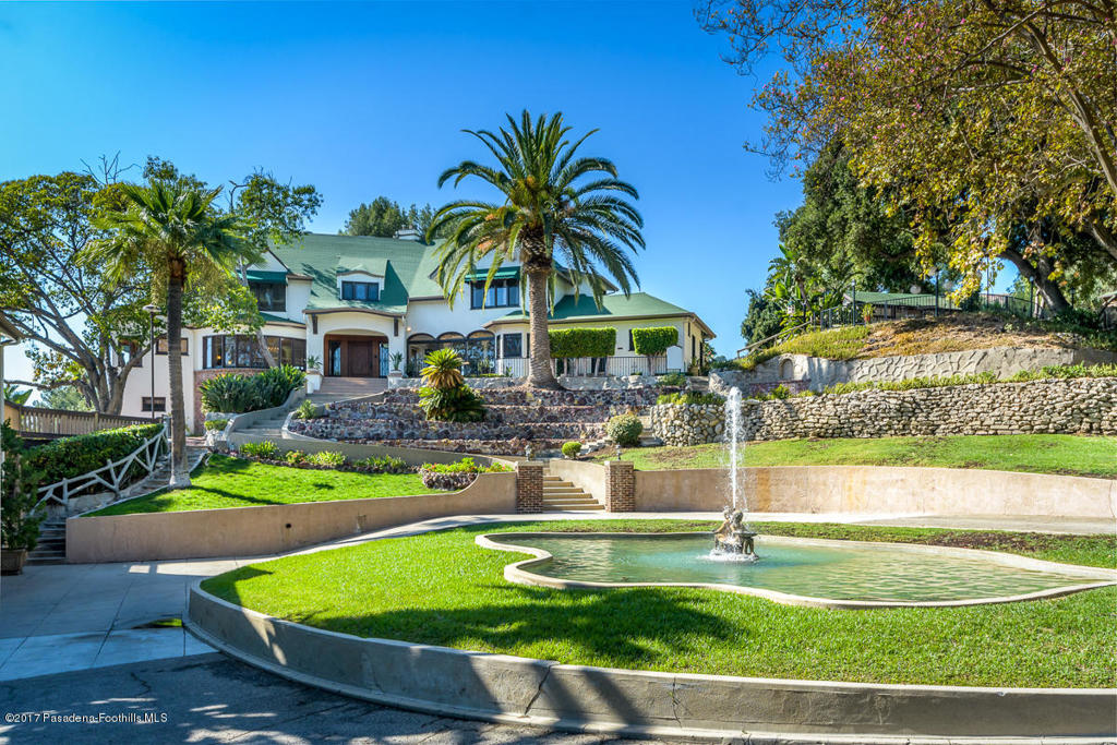 Stunning majestic estate property with commanding VIEWS known as ''The Chateau''. This gated, multi-acreage park-like manor presides over nearly 3 acres of meticulously landscaped grounds. Site of notable events including a US Presidential address to weddings, festivals, and family sporting events. Main house measures at 5942 sqft and has quality upgrades throughout with spectacular city views, a lower level game/billiards room w/bar and lounge. Additionally there are 3 all inclusive guest houses totaling 2,954 sq.ft. Endless entertainment opportunities include the outdoor ''Bistro Cafe'', croquet court, large pool/spa, fire pits, fully manicured park like DG pathways throughout, greenhouse and gardens. On site parking for 40 plus. A rare offering for one of LA's prestigious estates.