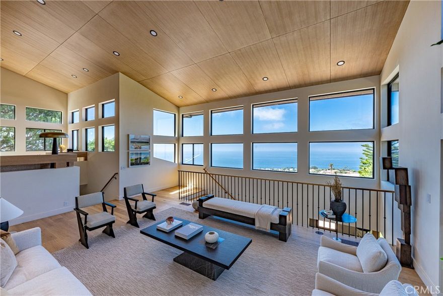 Mid-century modern reimagined! Completely remodeled, dazzling ocean view, this jewel blends timeless elegance with contemporary vibe. The Zen garden graced front path greets you with a mix of natural beauty and retro flare, the low-key wooden door opens to a world of sophistication and refined details.  The open floor plan boasts a wall of windows that invite the ocean view into the spacious kitchen and living room. Natural lights filtered through the sky light, light oak ceiling echos the wide plank engineered wood floor, all natural Arabescato Marble graces the kitchen island and the accent wall in the custom oak cabinets, curving oak island carries the theme of sleek contemporary design, paneled fridge hidden in harmony along with wine cellar and warming drawer.  The matte gold faucets pick up the sophistication of the lamp shades, the warmth of light oak railing flows effortlessly to the living room that’s anchored by the astonishing cast iron fireplace. The secondary living room a few steps lower creates another conversation area which makes an interesting architectural style.  The primary bedroom features a sleek travertine fireplace and an ocean view private patio. The en-suite bathroom showcases a custom Travertine vanity, and an oversized double shower that exudes spa-like luxury, accompanied by a free-standing bathtub. The unique layout of double staircases to the lower level ensures privacy with two nines rooms and one bathroom on one side, while 1 bed and 1 bath plus a push entertainment family room, decked out with a wet bar and wine rack, plenty of cabinets adorned with green marble that homage to the era’s design. Throughout the home, thoughtful touches like vintage light fixtures and bold geometric patterns stay true to the essence of mid-century modern, while modern updates ensure this home meets the needs of today’s lifestyle. All windows and doors are brand new. 

 Grassy backyard with a view deck enjoys full ocean view. This is a place where the charm of the past and the comforts of the present coalesce to create a living experience that is both aesthetically pleasing and thoroughly modern.