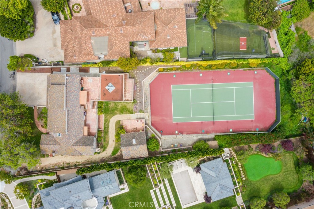 This one-of-a-kind property is on the market for the first time in fifty years, located within the original estate properties of the poet section of Manhattan Beach. This "non-splittable" lot boasts the largest lot size available in Manhattan Beach. This offering is an extraordinary opportunity for those seeking space and privacy. Positioned on over half an acre of land, this home captures attention with its unique location. It features four bedrooms and three baths, a breezeway leading to a three-car garage, and additional space for three more cars in the driveway. If you love to play tennis, a private court (one of only three in Manhattan Beach) is also perfect for pickleball enthusiasts and primed for updating. The estate includes an additional 1,700 square feet of usable space, featuring an ADU studio/tennis lounge and a spacious multi-purpose room previously used as an art studio not included in the current assessor square footage. Significant unused outdoor space also has potential for amenities such as a lap pool.