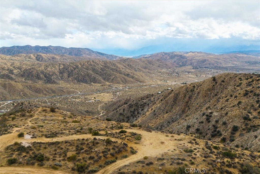 Owner Will Carry!
Breathtaking 5-Acre Mountain-Top Parcel with Panoramic Views!
Perched high above Yucca Valley, this remarkable 5-acre mountain-top retreat offers unparalleled 360-degree views of Morongo Valley, Yucca Valley, and the endless mountain ranges beyond. From this pristine vantage point, take in awe-inspiring vistas of the San Gorgonio Wilderness and the iconic landscapes of Joshua Tree National Park.
This unique property provides the perfect setting for your dream desert escape, offering privacy, serenity, and a front-row seat to some of the most stunning sunrises and sunsets the High Desert has to offer. Whether you're looking to build an architectural masterpiece, a weekend getaway, or an off-grid retreat, this once-in-a-lifetime property delivers an extraordinary opportunity to own a piece of the majestic Mojave.
With easy access to hiking, stargazing, and the artistic energy of Joshua Tree, this parcel embodies the best of desert living—where the sky meets the earth in perfect harmony. Don’t miss your chance to claim one of the most breathtaking view lots in all of Yucca Valley!