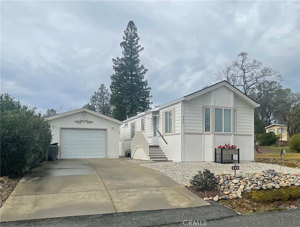 This beautiful open concept home features vaulted ceilings throughout. Home has newer central heat/air unit and newer washer and dryer. Detached garage had new roof put on last year. Lot has been graveled for easy maintenance. Located in The Oaks senior park, roads are all paved perfect for afternoon walks, also have access to the clubhouse and pool. Contact your favorite realtor today and check it out!!
