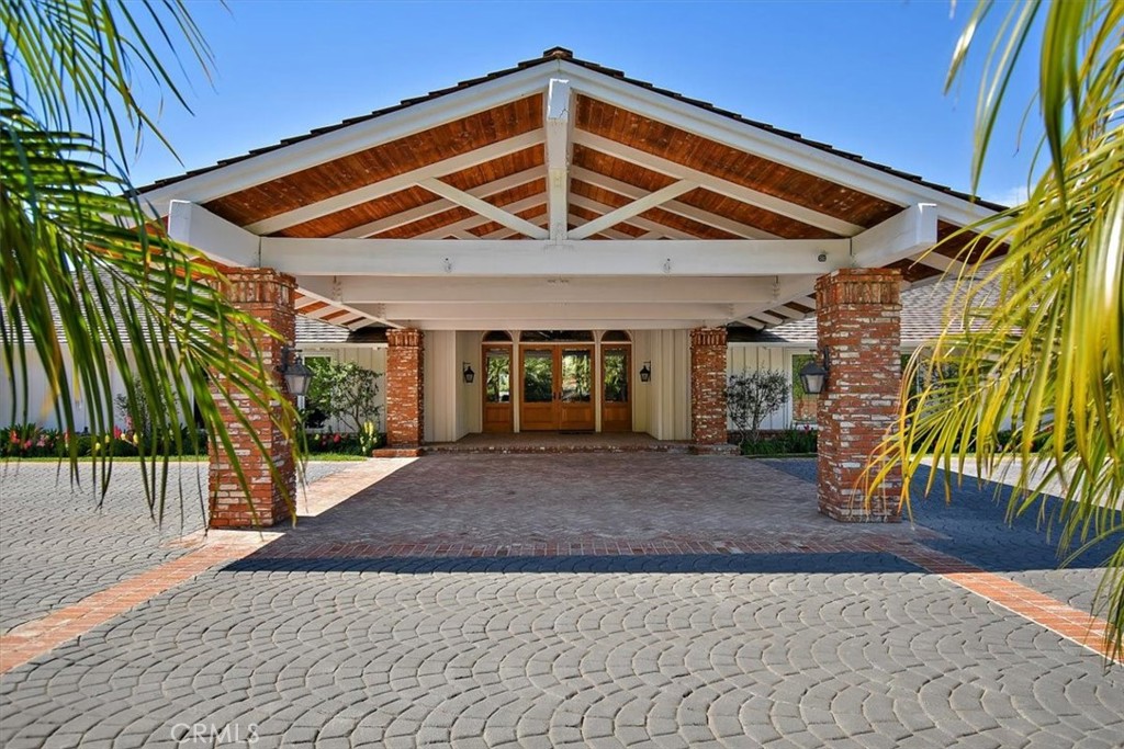 Nestled within the confines of a prestigious 24hr guard gated community, this impeccable ranch-style estate epitomizes luxury living with its unparalleled amenities and breathtaking surroundings. Meticulously built in 1989 with a subsequent multi million dollar remodel, this sprawling 8,250 sqft sanctuary sprawls over 5 acres of meticulously landscaped grounds, offering an oasis of tranquility amidst the hustle and bustle of city life. Upon arrival, a grand entryway adorned with a cascading waterfall sets the tone for the opulence that awaits within. A sprawling motor court, capable of accommodating 10 vehicles, greets guests with understated elegance. This estate boasts a plethora of recreational amenities, including a tennis court with pickleball and basketball overlays, a golf green with a sand pit, and a sparkling pool. A 2,200-gallon koi pond fed by 2 waterfalls adds a touch of serenity, while 4 built-in barbecues, 2 external fireplaces, 2 fire pits, and 3 TVs provide the perfect setting for outdoor entertaining. Entertainment options abound, with a media room, outdoor dining areas providing the perfect backdrop for gatherings. Sweeping city views of the entire LA Basin serve as a constant reminder of the amazing lifestyle afforded by this trophy property. There is a separate chef kitchen with 2 ovens/griddle/deep fryer,2 refrigerators, freezer, 3 bar fridges, 3 bar ice machines, 5 ovens and 12 range burners (both chef and family kitchen combined). Whether unwinding in the hot tub, indulging in a sauna session, or simply admiring the sunset from the comfort of the outdoor kitchen pavilion, every aspect of this estate has been meticulously designed. Orchard with 140 Trees with orange, lemon, avocado, fig, apple, & grapefruit and features such as a full gym, movie theater/game room, Lutron lighting, Creston System, wine cellar, and a safe room, this estate truly offers every amenity imaginable for the most discerning of buyers. Property boasts a 21-camera security system, a whole-house alarm supported by fiber-to-the-home internet access for the utmost in security and connectivity. 5 zone AC and heating allows each room to be controlled on its own. Amenities include a 4 car garage and a full professionally outfitted workshop and finished barn structure w/ external shed, full house generator, 2 laundry rooms, full house PBX phone system, two 100 gallon water tanks, water softener system, AV distribution system to serve virtually every room.