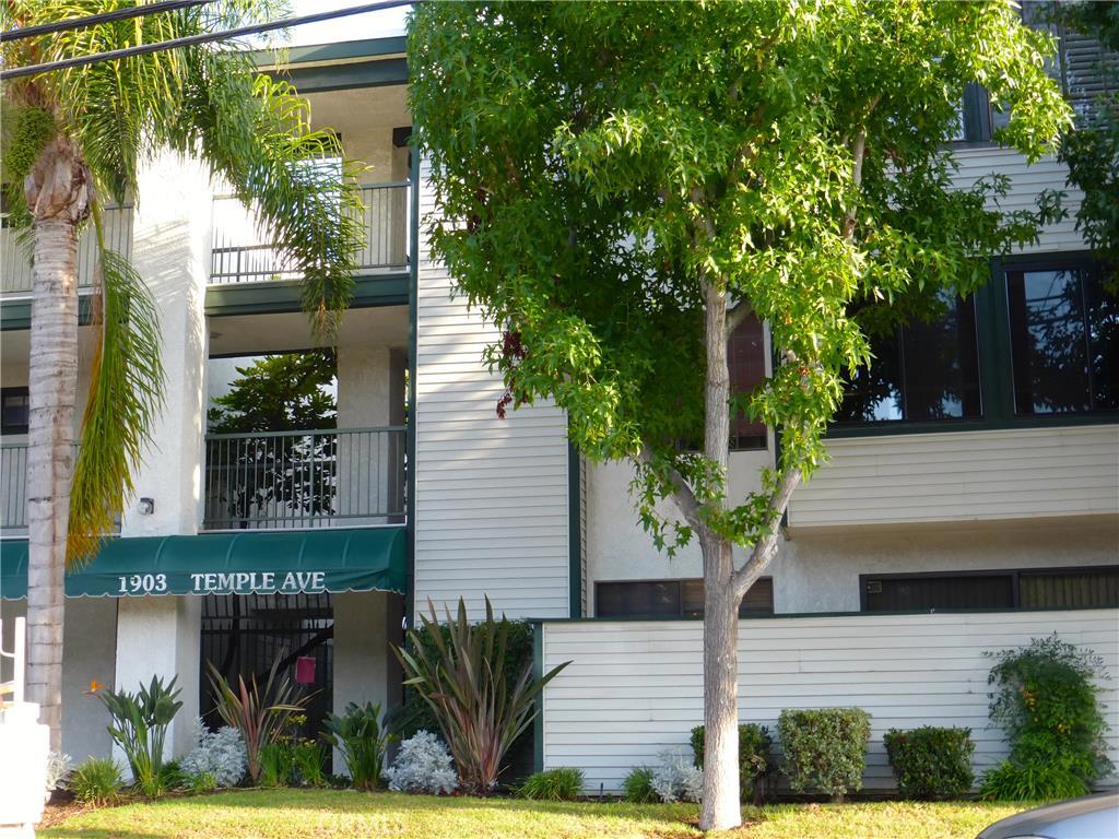 Spacious upgraded Hillbrook Condo with open floor plan. Living room features warm gas fireplace next to balcony with tree view and a spacious area off to left side. Dining area adjacent to open fully equipped Kitchen. Recessed lighting. Upgraded top grade Brazilian Cherry laminate flooring, tile and carpet. In unit Laundry. Large Master suite includes two double sliding closets. Master bath includes sink, vanity area and storage. Separate room for shower/ tub, commode and storage. Unit has central A/C. HOA Dues include many amenities: Club house, gym, pool and spa with pool side shower. Dues include water and Basic Verizon FIOS. Great location close to beach, freeways, shopping, parks and recreation including walking trails. Unit has two assigned parking spaces one private enclosed with storage. Parking spaces conveniently close to unit stairs and elevator. Easy access to gated pool. Desirable Signal Hill Location in gated community providing a secure environment. See showing instructions and agent remarks.