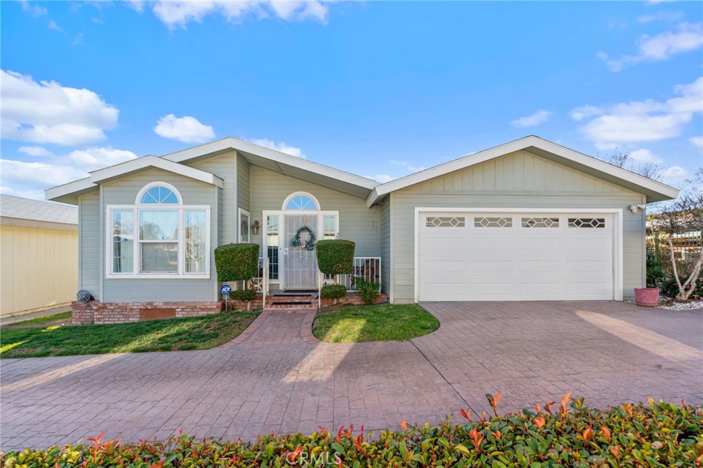 Imagine waking up each morning in a beautiful Valencia Lea 55+ park home, surrounded by tranquility and opportunity. This 1464 sqft haven features 2 bedrooms, 2 baths, and a versatile bonus room. The kitchen is perfect for culinary creations, with a center island, breakfast nook, and included appliances. Relax in the spacious living room, enjoy the fresh air on the expansive covered patio, or take advantage of the numerous community amenities. With its prime location and abundance of amenities at the end of the street this home is the perfect choice for those seeking a relaxed, fulfilling lifestyle.