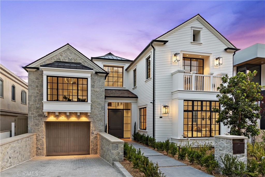 A collaboration between some of the most respected names in coastal luxury home development, this meticulously planned Bayfront estate takes waterfront luxury living to a new level. Situated on Bayside Drive, the traditionally designed home offers a combined 10,900 sqft of elegant indoor & outdoor living across four levels, an infinity pool & spa, rooftop deck, & shared ownership of the longest private deep-water dock on the West Coast (accommodating approx. an 100-ft and 75-ft yachts). Optimal panoramic ocean, harbor and sunset views abound from multiple vantage points. On the main level, the home highlights a two-story atrium, three-stop elevator, chef-inspired kitchen with a butler’s pantry, central private courtyard, a spa/gym, office that could be converted into a 6th bedroom, and a private guest suite. The second level offers a grand master wing that stretches along the entire width of the home with a private fireplace retreat, sitting room, generous balcony, and dual grand master baths and closets. The lower level includes a 2,800+ square foot 5+ car garage, a California mudroom, beach storage, theater room and a wine cellar. An expansive rooftop deck with panoramic views completes the home. Designed by Brandon Architects and brought to life by Patterson Custom Homes & Brooke Wagner Design, 2209 Bayside Drive is undoubtably one of the most impeccable bayfront estates on the Newport Harbor.