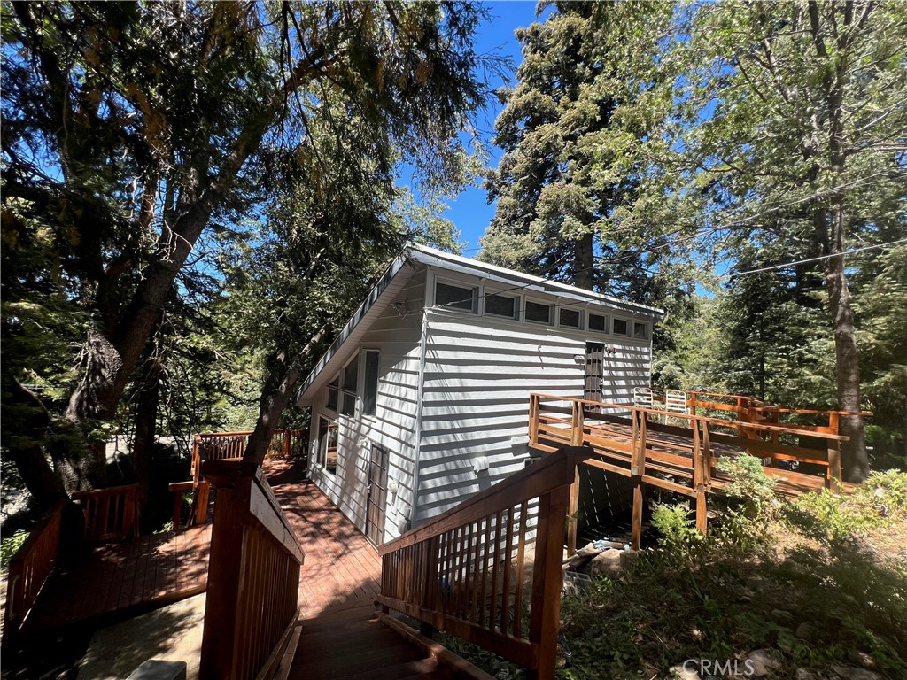 If you are looking for a project this mountain fixer is a must see. Enter from the top deck into the loft bedroom or the bottom deck into the kitchen main floor. Newer decking, newer roof and newer dual pane windows. Living room opens out to the back deck area. Small office or dining area off of living room. Kitchen opens to the living room with an eat at bar. The bathroom makes up the main level. Upstairs has a loft bedroom and access to the front deck. Enjoy the side yard with garden potential. The buildup has electricity and could be used as a workshop or finished for an apartment. Kitchen, bathroom and flooring area needed. This house is a cash only fixer. Private setting at the end of a cul-de-sac and nestled in the trees, this cabin could be 'the one' for your next project. Close to hiking trails and minutes to the local ski resort.