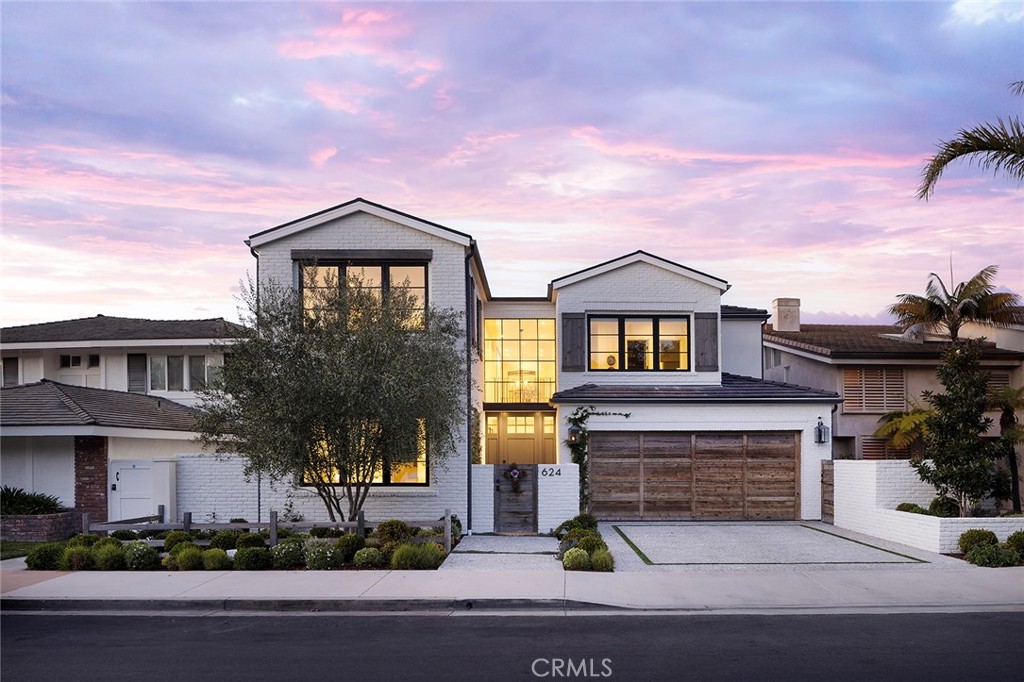 Designed for effortless waterfront living, 624 Harbor Island Drive blends refined coastal design with modern functionality. Originally built in 2020, the home underwent a comprehensive transformation in 2022, thoughtfully reimagined by Kelly Nutt Design and Garden Studio Design, with expert execution by Devco Custom Homes. Every detail was carefully considered, resulting in a residence that is both visually stunning and exceptionally livable. Spanning 4,669 square feet, the open-concept living spaces are framed by floor-to-ceiling glass, inviting natural light and bay views throughout. The great room, anchored by a fireplace and custom millwork, transitions seamlessly into the chef’s kitchen—an elegant balance of form and function. Marble countertops, a farmhouse sink, and top-tier appliances, including dual Sub-Zero refrigeration and a Wolf range, elevate the space. Nearby, a state-of-the-art theater with Dolby Atmos sound and a Sony 4K projector offers an immersive cinematic experience, while a dedicated office provides a quiet retreat. Five en-suite bedrooms, including a detached guest casita, ensure both privacy and flexibility. The primary suite is a sanctuary of its own, complete with a fireplace, private balcony, and gym. Its spa-like bath features dual vanities, a soaking tub, and a custom walk-in closet. Wide-plank white oak floors and shiplap detailing enhance the home’s timeless aesthetic, while modern technology—including a Control4 smart-home system—adds convenience and ease. Outside, the bayside terrace is designed for both intimate gatherings and large-scale entertaining, with a built-in Lynx barbecue, an open-air fireplace, and space for alfresco dining overlooking the water. A private dock accommodates a vessel up to 54 feet, with additional side ties for a Duffy or personal watercraft. A rare opportunity to own a meticulously crafted waterfront home where understated luxury meets the ease of coastal living.
