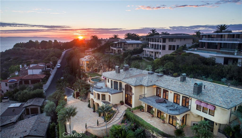 This spectacular ocean view property stands as one of a handful of true estate homes in Laguna Beach. Behind ten foot privacy gates, the entrance motor court provides only a glimpse of the sprawling one and a half acre grounds. The main house - with grand public spaces - easily accommodates large scale events without sacrificing more intimate spaces suited for comfortable every-day life. Spacious grounds, also with magnificent coastline views, are centered on a masterpiece infinity-edge pool with a separate guest house anchoring one edge of the property. The main house includes five bedroom suites, a library, theater, office, six fireplaces and a nine car garage. An elevator services all levels. The master suite, at over fifteen hundred square feet, is a retreat unto itself. Carefully crafted artisan stonework and forged iron compliment the quality finishes and fixtures throughout. The home is just minutes from the charming downtown of Laguna, the best beaches, and schools. Rare in both it's size and prime locale, this Laguna Beach estate may be impossible to duplicate.