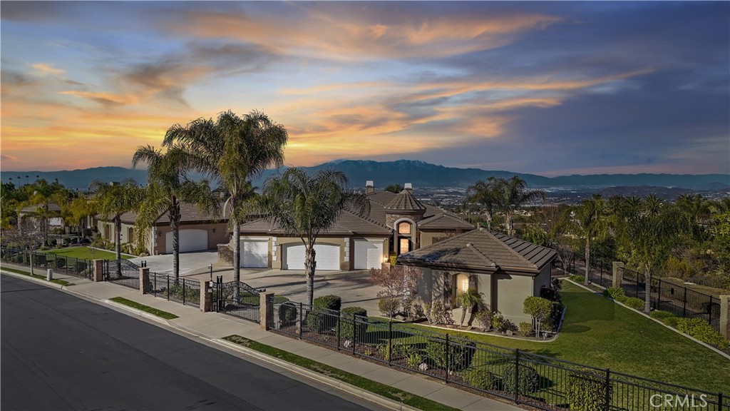 Your dream home has hit the market!! This stunning single-level 4,058 sq. ft. Amberhill estate in the highly sought-after Pinnacle community offers an unparalleled blend of luxury, space, and functionality. Featuring four generously sized bedrooms and four bathrooms, this home is designed for both comfort and entertainment. A 12-car garage provides ample room for car enthusiasts, extra storage, or a workshop space, with epoxy-coated floors and ample cabinetry throughout. The garage setup includes a 4-car attached garage, a 6-car detached garage, and an additional 2-car detached garage.
Inside, new luxury vinyl plank flooring and plantation shutters enhance the home’s modern and elegant aesthetic. The family room boasts a custom-built entertainment center, seamlessly connecting to the open-concept kitchen. A chef’s dream, the kitchen features granite countertops, a 48” built-in refrigerator, dual ovens, a walk-in pantry, and a full bar area—ideal for hosting gatherings.
Step outside into your private backyard oasis with breathtaking views. Designed for entertaining, the 1,250 sq. ft. outdoor living area includes surround sound, a built-in BBQ, two fire pits, an outdoor refrigerator, and an ice machine. The resort-style pool and spa, easily managed by the AquaLink system, create the perfect retreat. The beautifully landscaped yard features custom pavers, stamped concrete, extensive outdoor lighting, and 24 mature fruit-bearing trees. Additionally, a wrought iron dog run is conveniently located on the side yard.
For added security and peace of mind, the home is fully gated and equipped with an 18-camera security system recording 24/7, along with a 12-camera Ring system. Freshly updated with new interior and exterior paint, the property also features new 5-ton and 3.5-ton AC units for year-round comfort.
This extraordinary estate seamlessly blends modern amenities, elegant design, and breathtaking outdoor spaces in one of the most coveted communities. Don’t miss this rare opportunity—schedule your private showing today!
