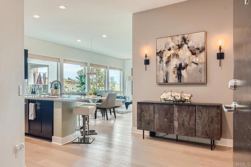 Welcome to your dream home! This stunning 2-bedroom, 2-bathroom unit features upgraded white oak floors and 12x12 porcelain tile in the bathrooms, along with a spacious office perfect for working from home. The open floor plan includes a large kitchen island, ideal for gatherings, and floor-to-ceiling windows in the living room that flood the space with natural light, complemented by custom motorized window shades. The primary bedroom boasts a custom coffered wall and a custom closet, while the pantry near the washroom includes custom cabinets and shelving. Facing east, this second-floor unit welcomes beautiful sunrises every morning and is accessible by elevator or stairs. The serene community offers exceptional amenities, including a rec center with barbecue grills, two pools, spas, cabanas, lounge chairs, a gym, meeting areas, fire pits, games, a pool table, and a kitchen for entertaining. Adjacent to Civita Park, you can enjoy summer concerts, weekly food trucks, playgrounds, walking trails, dog parks, and more. This home offers a perfect blend of luxury, convenience, and community. Welcome home!