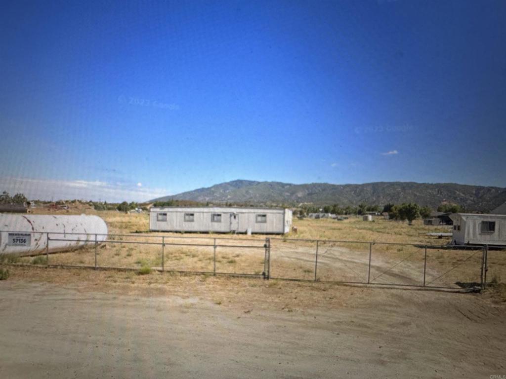 Prime Property for Sale: Two separate flat parcels being sold together and conveniently located along highway 371 in Anza with residential and commercial zoning (Manufacturing-Medium and Light Industrial). Parcels are 1.5 acres each (APN:575090013 and APN:575090014). The property is fully fenced and features an established high capacity water well which yields 100 gallons per minute. Original cost of well was 80k. There is a 400-amp electrical connection to the water well. Structures on the property include a 2100 sq ft double wide trailer that is in need of repair and does not have electricity or sewer hookup but can be converted into an office or live space. The land is level and ready for construction with minimal preparation required. This versatile property is perfect for a mixed-use development, small business, or a private residential home with ample space for expansion. Listing Agent is related to Seller.