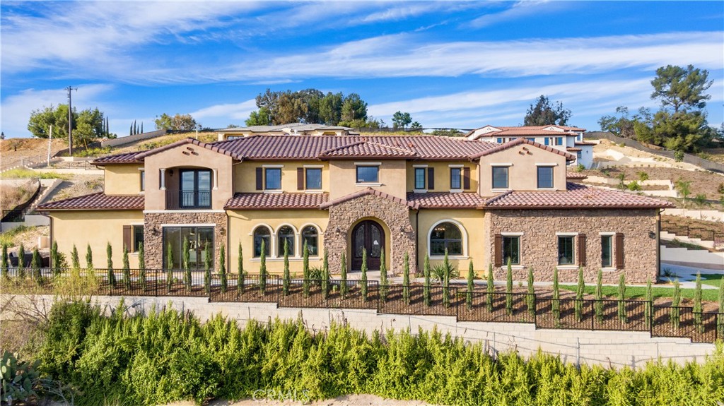 Nestled in the beautiful hills of Walnut, this Brand-NEW Custom Home is awaiting your presence. As you drive up to this Spanish marvel of a residence, you are greeted with breathtaking panoramic views. Upon entering the grand foyer, the soaring ceilings impart a sense of majestic luxury. Directly ahead upon entry, the formal dining room and formal living room are bathed in natural light, accentuating the uncompromising quality of this home. There are a total of six spacious bedrooms, with two located on the first floor for your, your family's, and your guests' comfort and convenience. The six bathrooms are all exquisitely designed and stylish. The meticulously designed kitchen provides an exquisite space for cooking and entertaining friends and family. There's even an equally refined Chinese-style kitchen to allow for more culinary creativity. The wine cellar design adds a touch of modern sophistication to the entire house. The large family room adjacent to the kitchen is perfect for gatherings and events. With a flowing layout, this home showcases its spacious 6,288 square feet. To top off all the remarkable features and quality of this home, it is also situated in the highly sought-after Walnut Unified School District. Come see this gem of a property in person to appreciate each of its magnificent features. This incredible find is sure not to disappoint.