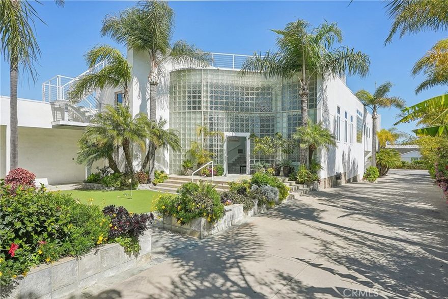 A rare opportunity to own a one-of-a-kind gated estate in Newport Beach, offering an unmatched combination of luxury, versatility, and space. Set on nearly half an acre, this custom property boasts newly renovated, high-end bathrooms, expansive living and entertaining areas, and a rooftop patio with easy stair access—perfect for taking in panoramic views. Ideal for car collectors and adventurers, the estate features two oversized garages with ceilings high enough for lifts and storage for over 30 vehicles, plus a 40' RV garage complete with full hookups and a dedicated workshop. Designed for both sophistication and function, the home includes dual offices, a chef’s kitchen equipped with multiple ovens and dishwashers, an ADA elevator, and an indoor/outdoor entertainment retreat complete with a cigar patio, fireplace, and surround sound. Located just above Upper Newport Bay and minutes from the airport, this is a truly unique chance to build your dream lifestyle—right in the only part of Newport Beach zoned for equestrian use!