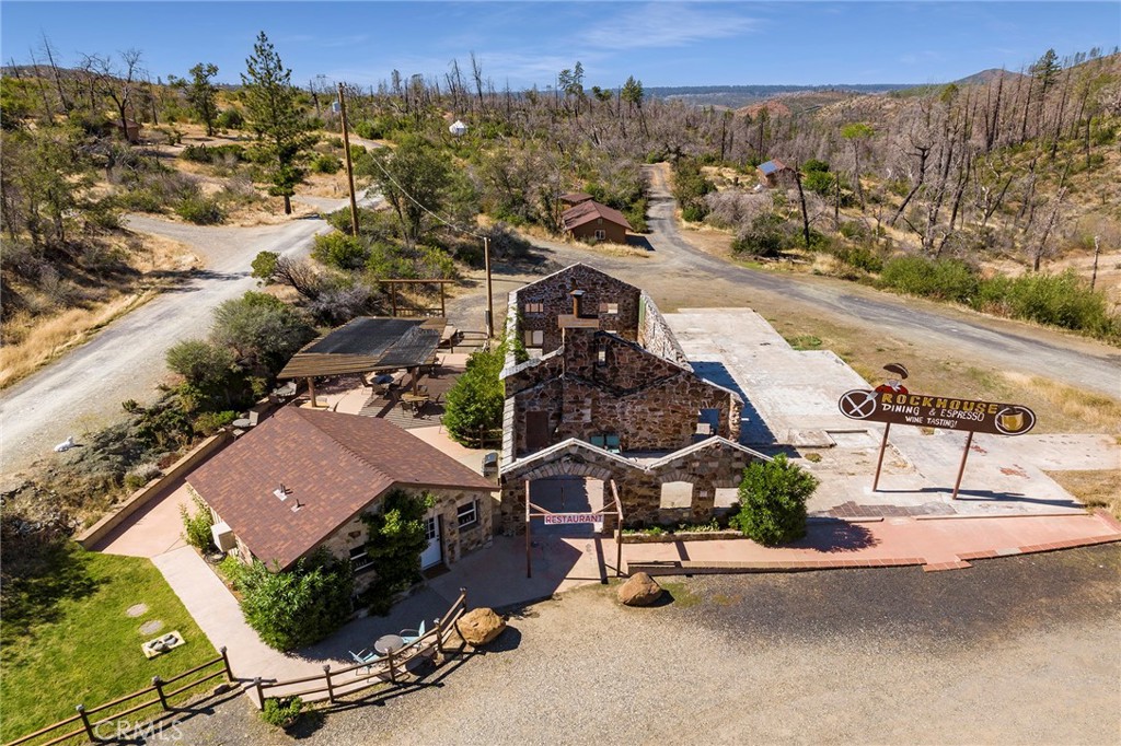 Nestled in the majestic Sierra landscape along the scenic Feather River Highway 70, this unique 76-acre property offers an extraordinary mix of residential and commercial opportunities. At the heart of the property is a newly constructed, energy-efficient 2-bedroom, 1-bath stick-built home with solar power, a spacious garage, private well, and septic system. Explore the captivating history of the Rock House restaurant, a one-of-a-kind structure built from local riverbed stone that evokes nostalgia for locals and visitors alike. Additionally, a cozy coffeehouse equipped with sink and food prep station offers a warm, inviting space for patrons. For those seeking a serene retreat, a fully furnished yurt provides an idyllic weekend getaway spot with all the amenities you need. Outdoor enthusiasts will enjoy the trails, three camping sites, and four full hook-up sites, as well as RV accommodations, a communal fire ring with bench seating, a flourishing garden, and a chicken coop. Across the highway lies additional residential acreage, ideal for expanding the property’s potential. With both natural beauty and commercial infrastructure, this property is a rare gem for investors, developers, or those seeking a private sanctuary.