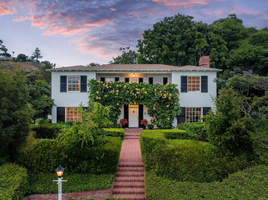 This potentially historic home was designed by Edgar Ullrich during the development of Upper Hermosa and embodies the architectural and landscape elements that define this neighborhood, and may benefit from reduced property taxes via the Mills Act. The two-story home is situated on a lot graced by mature landscaping and a 100-year old tree planted by Kate Sessions that creates a captivating canopy and unrivaled ambiance. Original design details like the impeccable millwork, distinctive chimney, grilled doors & windows and wooden shutters adorn this prominent property, showcasing its timeless charm. The entry level boasts a versatile office, as well as formal dining & entertaining spaces that open to the backyard. The upstairs features a spacious primary suite with an adjoining room, ideal for private retreat or nursery. Additionally, there are two secondary bedrooms, and front & rear balconies that offer picturesque views. A kitchen remodel in the 80s created a family room and sunroom with easy access to the spacious backyard that is perfect for relaxation and entertainment. Furthermore, the home's elevation sited above the street affords privacy and superb horizon ocean views with close proximity to La Jolla's fine amenities. This property is an extraordinary example of grand living in a bygone era that has stood the test of time and is a generational opportunity that blends history, craftsmanship and unmatched elegance.