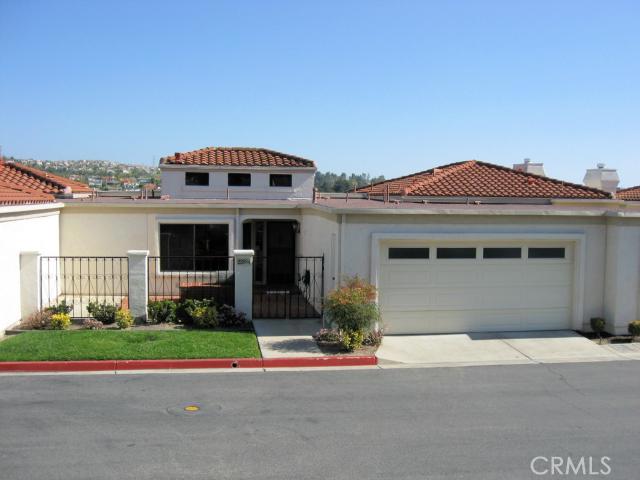 Magnificent views of Lake Mission Viejo, city lights & mountains from main living areas, master suite & view deck off the living room. Well located "town home" features a gated courtyard w/built in BBQ island for outdoor entertaining. Community beach, swim area, BBQs, picnic area & boat docks! Great room boasts high ceilings w/lots of windows that fill the room w/natural light. Cozy corner fireplace & sliding glass doors lead to a view deck. Kitchen looks out to the great room & adjoins a roomy breakfast nook overlooking the courtyard. Convenient main floor master suite w/views of the lake, city lights & mountains. Dual master closets w/mirrored wardrobe doors, dual sinks, oval soaking tub, & a large step in shower. Powder room off the foyer. Separate laundry area w/sink & storage cabinets located just inside the garage (could be enclosed into a laundry room). Two lower level bedrooms w/partial lake views, shutters, & sliding door closets. One w/built in desks & bookcases, track lights. One bedroom opens to a downstairs patio. Full hall bath downstairs. Attached 2 car garage w/shelving & closets. New A/C unit w/in past year, & all new pluming in Dec. 2014. Just scraped the ceilings, removed wall paper & freshly painted inside!